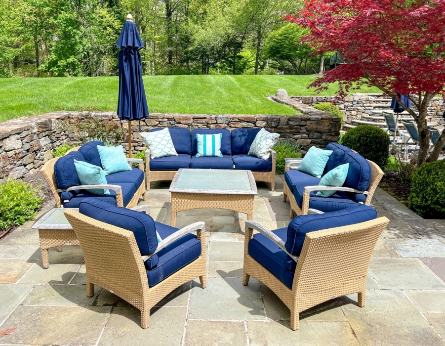A six piece Weathered Teak and Outdoor Wicker Conversation Set by Gloster.
